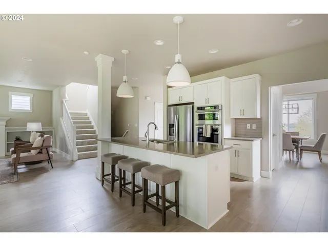a large kitchen with a table and chairs