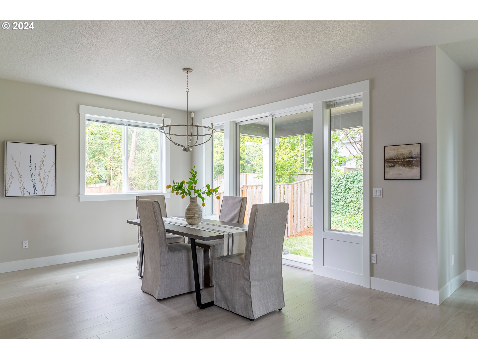17683 Southwest Cobb Lane Beaverton, OR 97007 - Photo 13 of 27 a dining room with furniture a chandelier and wooden floor