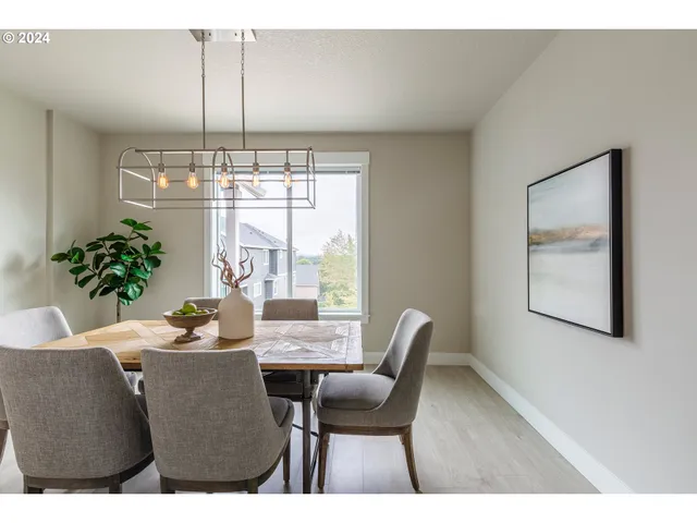 a dining room with furniture a chandelier and window