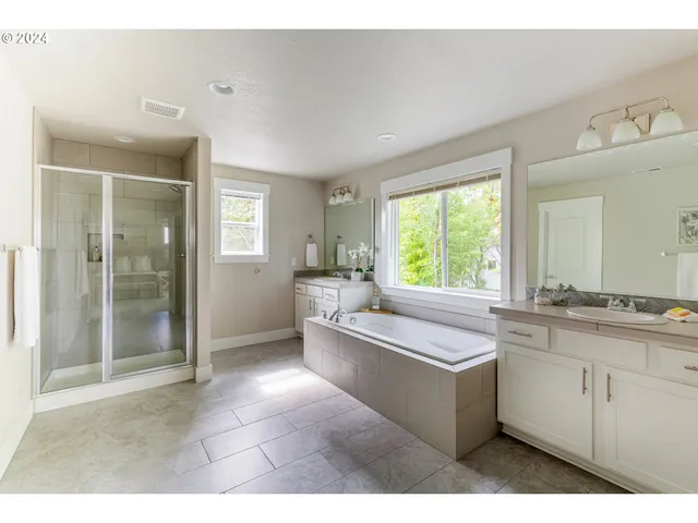 a large white kitchen with a large window