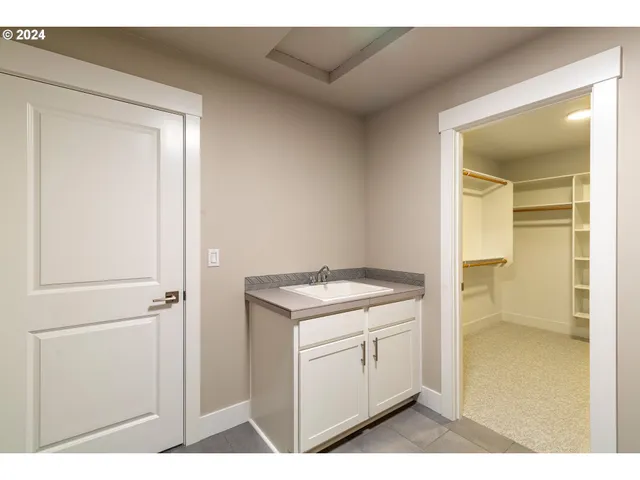 a utility room with cabinets washer and dryer