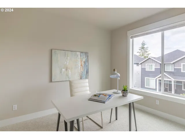 a view of a dining room with furniture and a large window