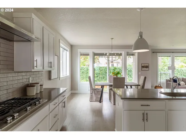 a kitchen with sink a stove and cabinets