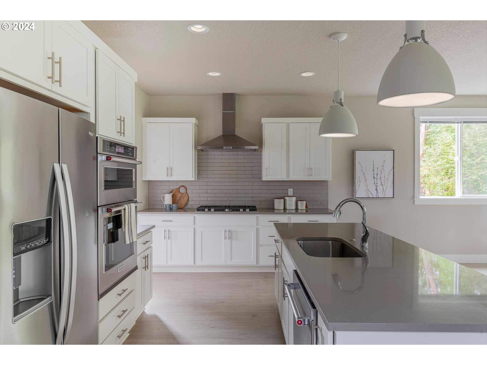17683 Southwest Cobb Lane Beaverton, OR 97007 - Photo 9 of 27 a kitchen with kitchen island a sink stainless steel appliances and window