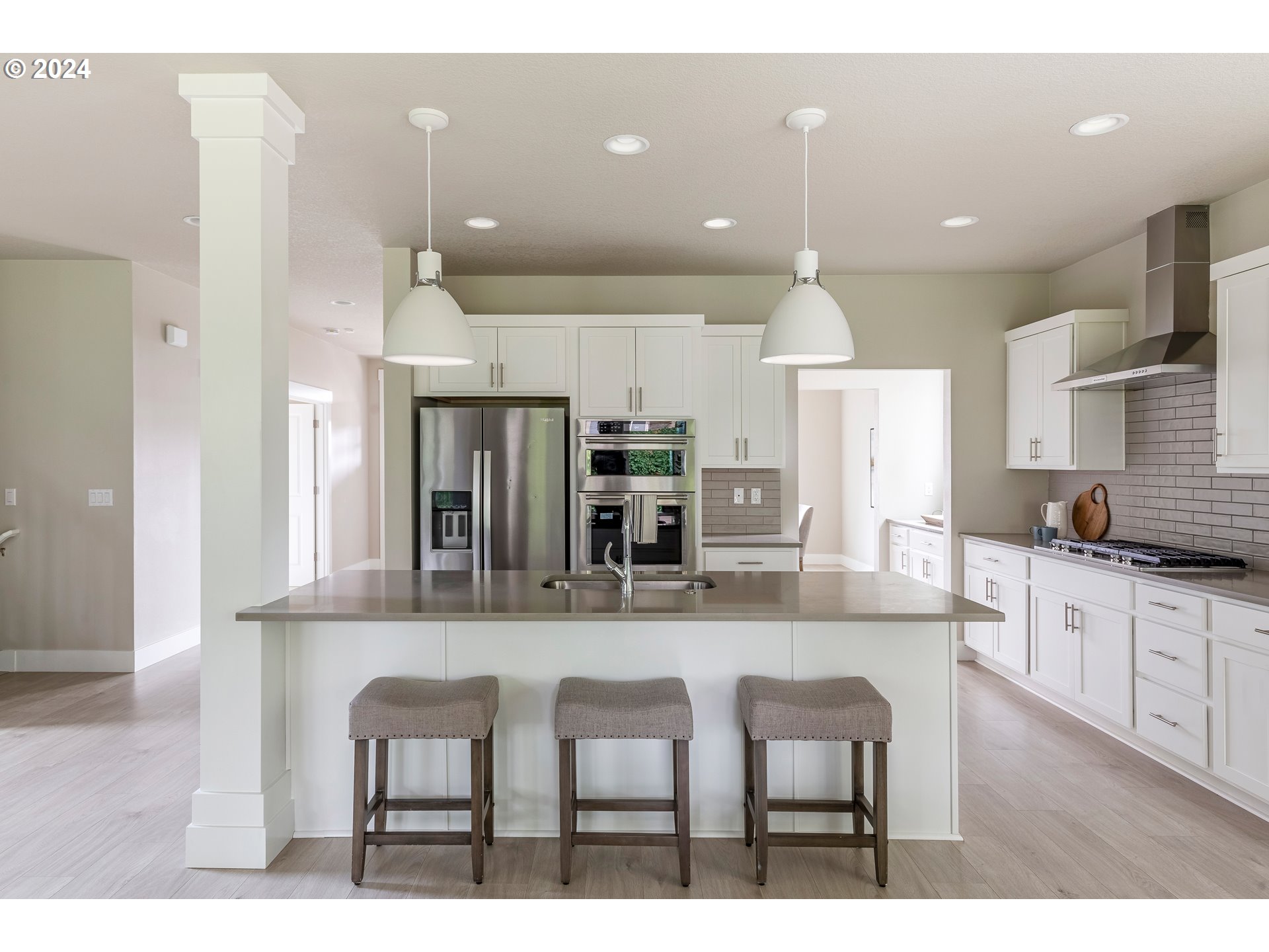 17683 Southwest Cobb Lane Beaverton, OR 97007 - Photo 10 of 27 a kitchen with kitchen island granite countertop a table and chairs in it
