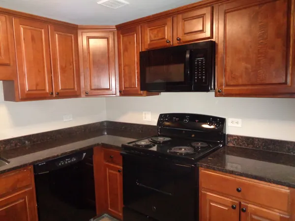 a kitchen with a stove microwave and sink