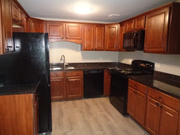 a kitchen with a sink a stove and refrigerator