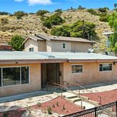 a view of a house with a backyard