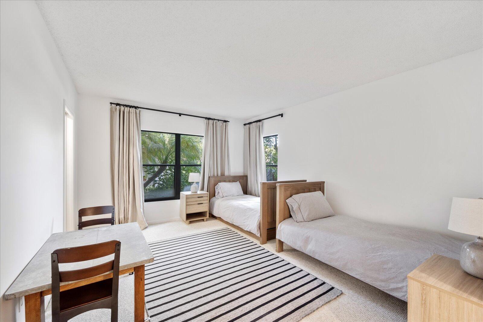 13307 Polo Club Road, Unit C106 Wellington, FL 33414 - Photo 19 of 25 a bedroom with furniture and a large window