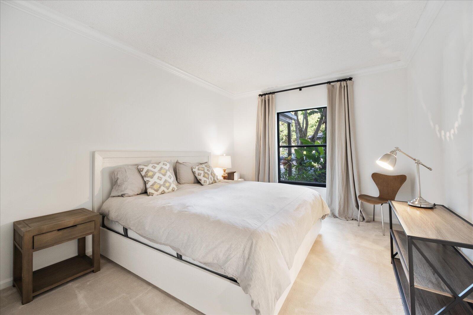 13307 Polo Club Road, Unit C106 Wellington, FL 33414 - Photo 21 of 25 a bedroom with a bed and a lamp next to a window