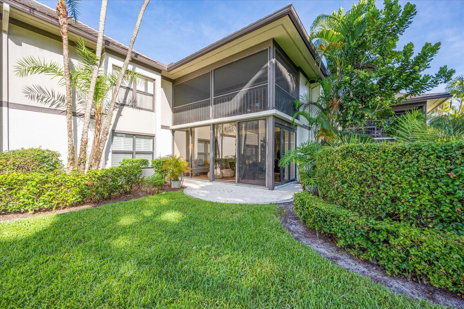13307 Polo Club Road, Unit C106 Wellington, FL 33414 - Photo 25 of 25 a view of house with backyard porch and garden