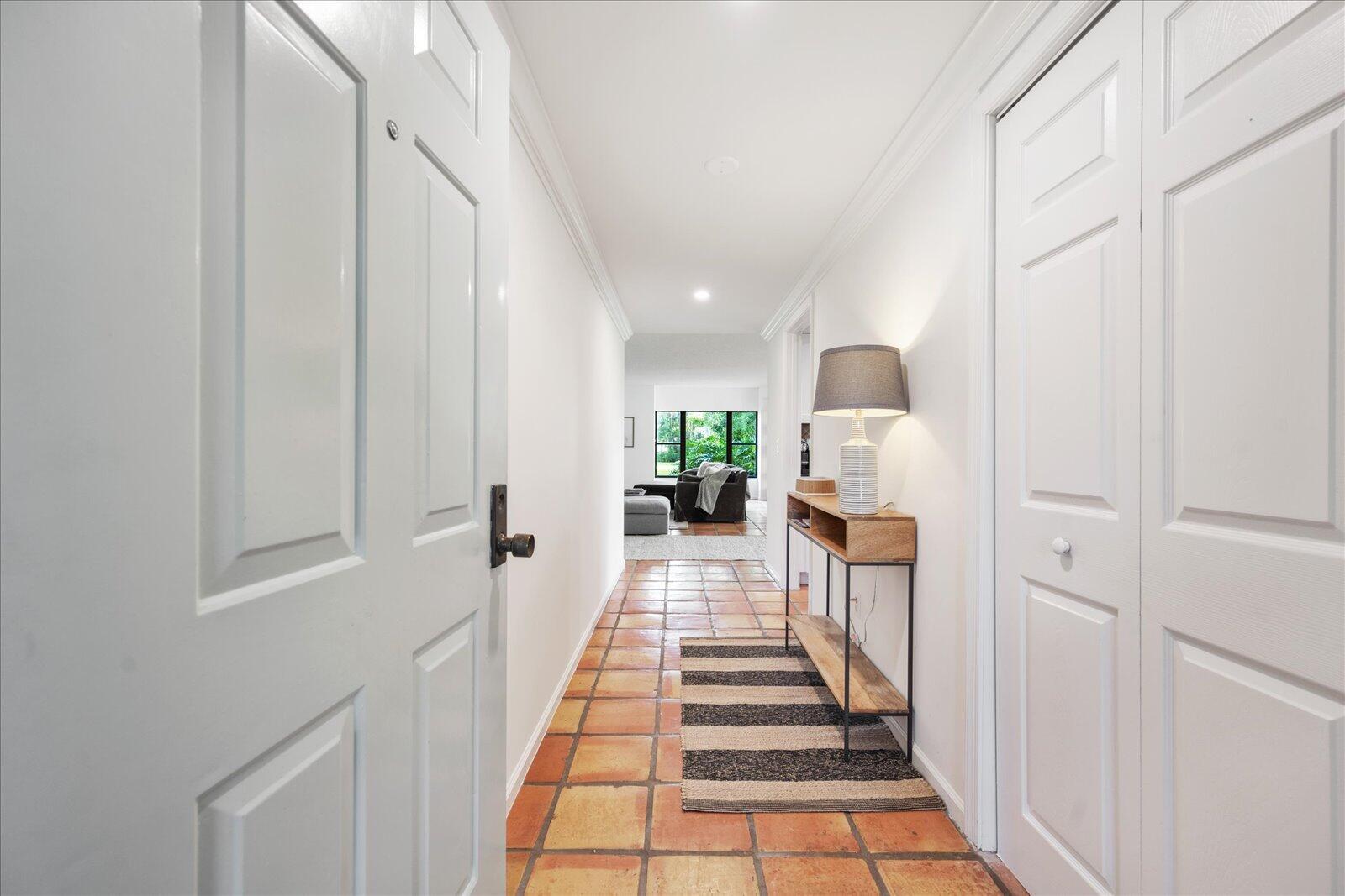 13307 Polo Club Road, Unit C106 Wellington, FL 33414 - Photo 4 of 25 a view of a hallway with wooden floor and a staircase