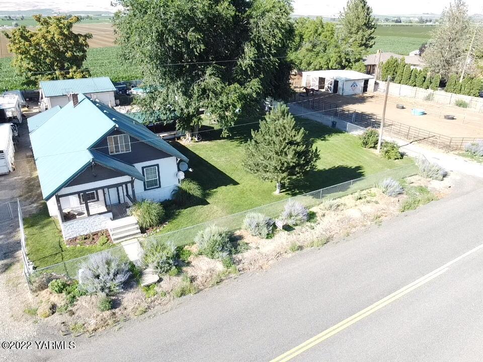 an aerial view of a house with a yard and garden