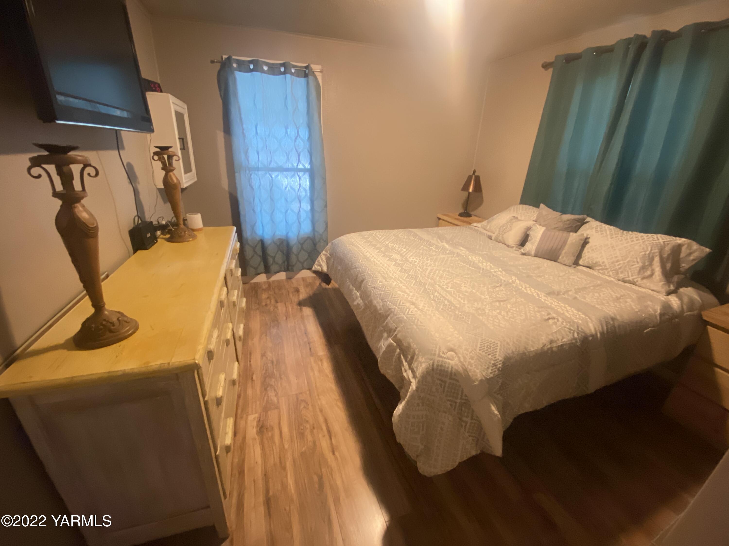 91 Arrowsmith Road Sunnyside, WA 98944 - Photo 11 of 19 a bedroom with a bed and teddy bear on bed