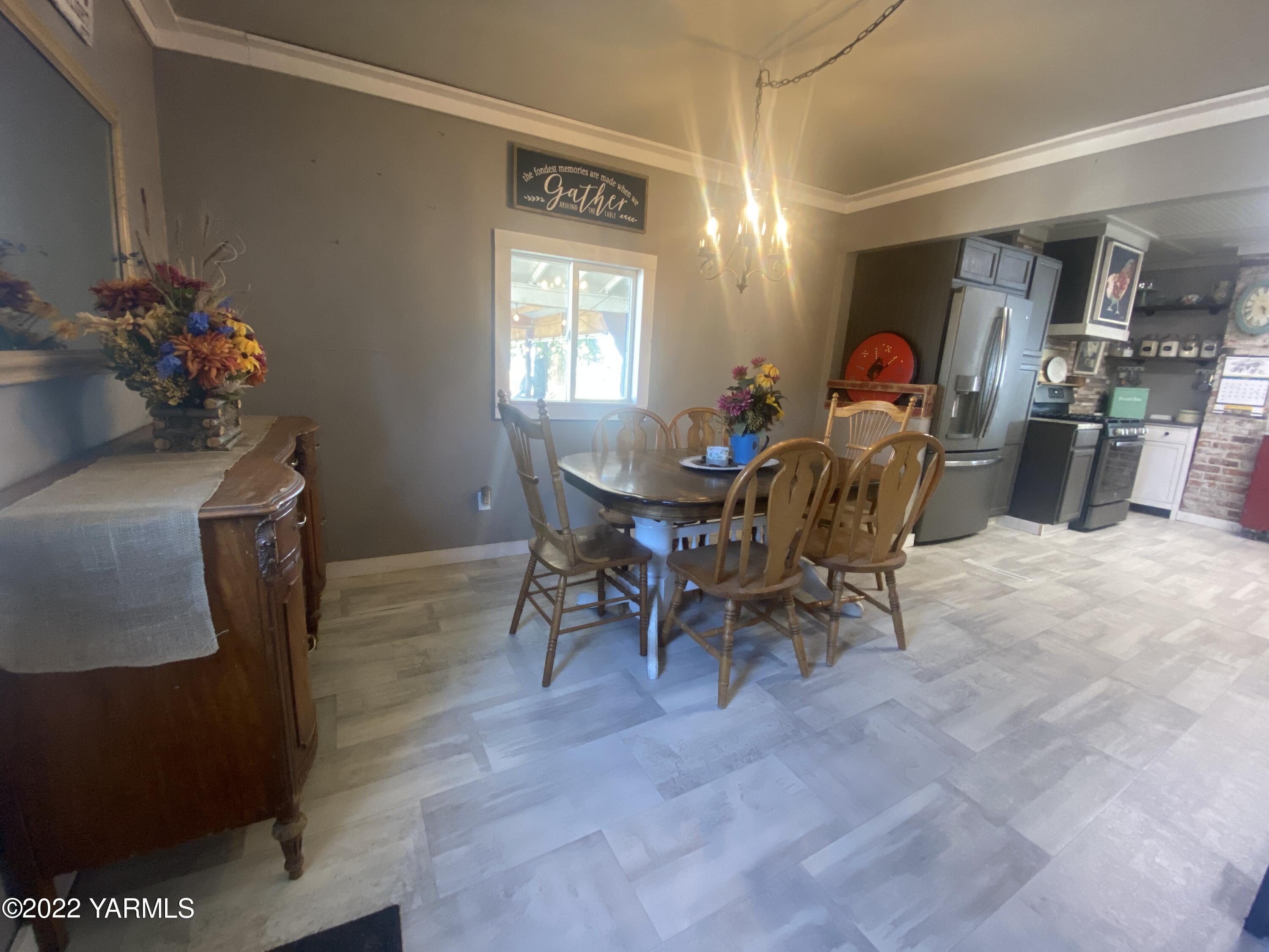 91 Arrowsmith Road Sunnyside, WA 98944 - Photo 7 of 19 a view of a dining room with furniture and chandelier