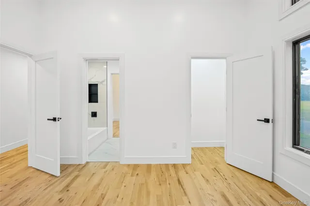a view of empty room with wooden floor