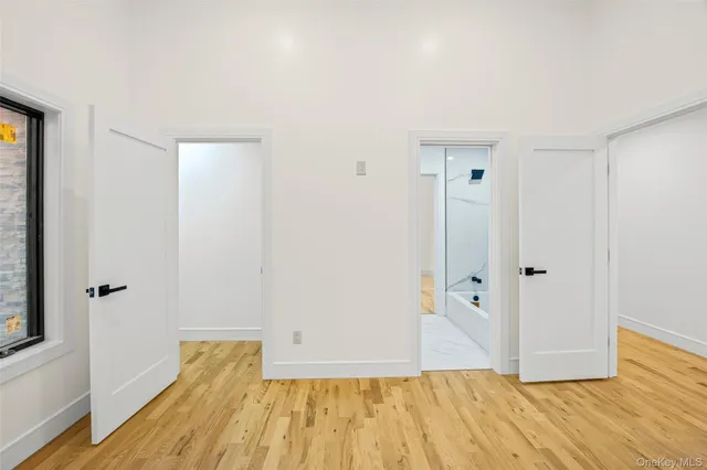 a view of room with wooden floor and bathroom
