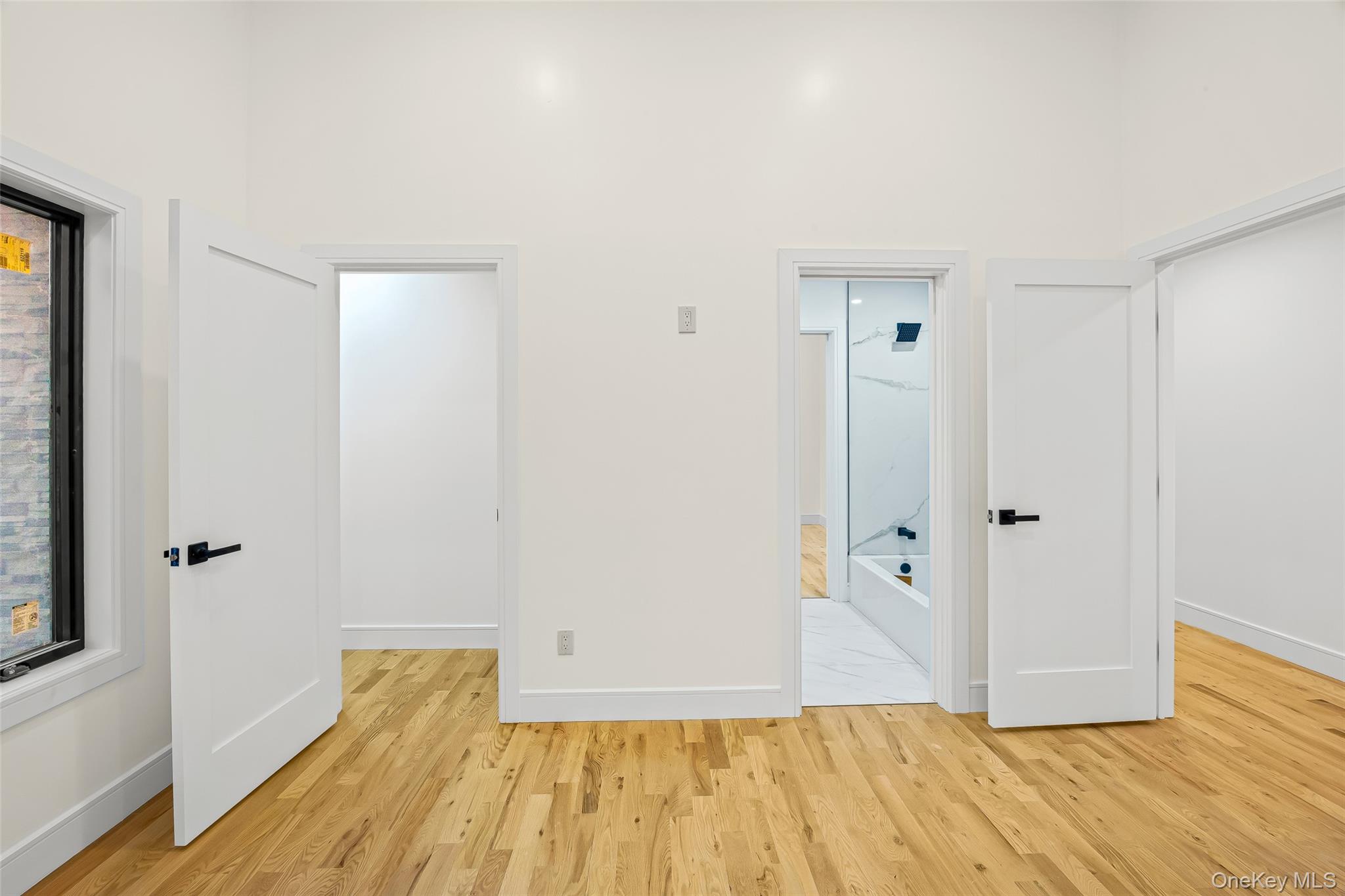 26 Tremont Avenue Patchogue, NY 11772 - Photo 20 of 50 a view of room with wooden floor and bathroom