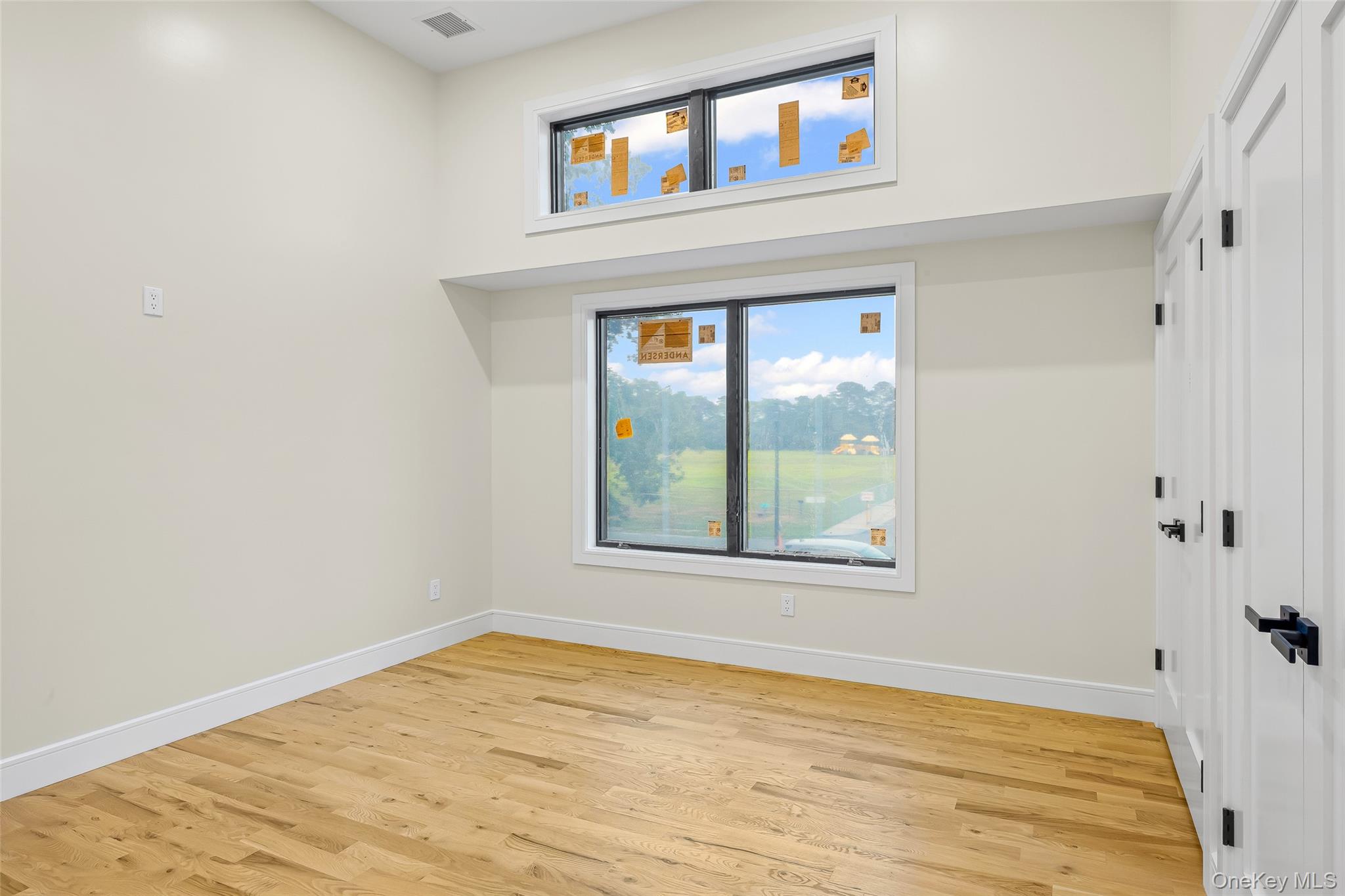 26 Tremont Avenue Patchogue, NY 11772 - Photo 23 of 50 a view of an empty room with wooden floor and a window