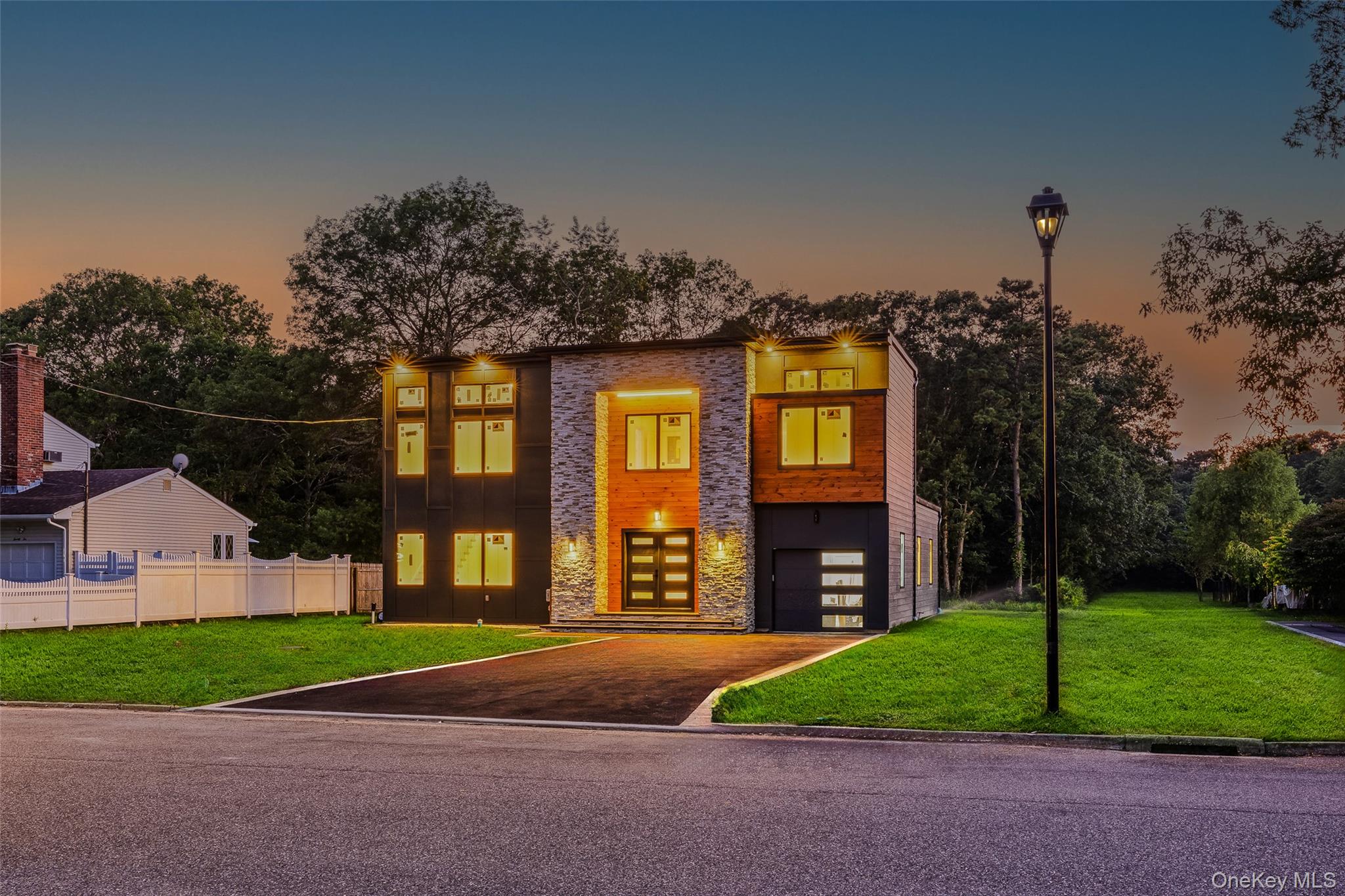 26 Tremont Avenue Patchogue, NY 11772 - Photo 3 of 50 a front view of a house with a yard and garage