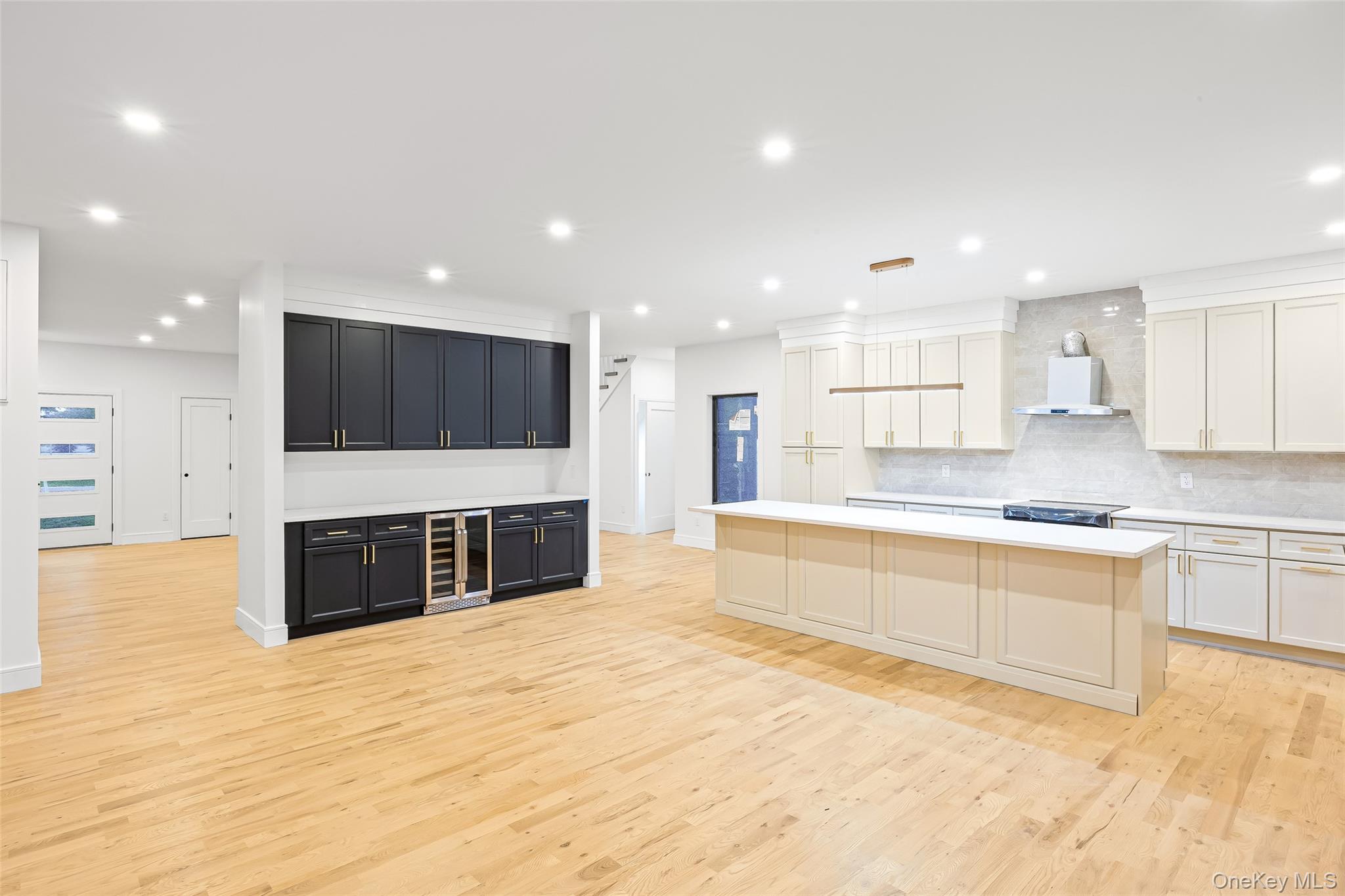 26 Tremont Avenue Patchogue, NY 11772 - Photo 35 of 50 a large kitchen with stainless steel appliances kitchen island a large counter top and a stove top oven