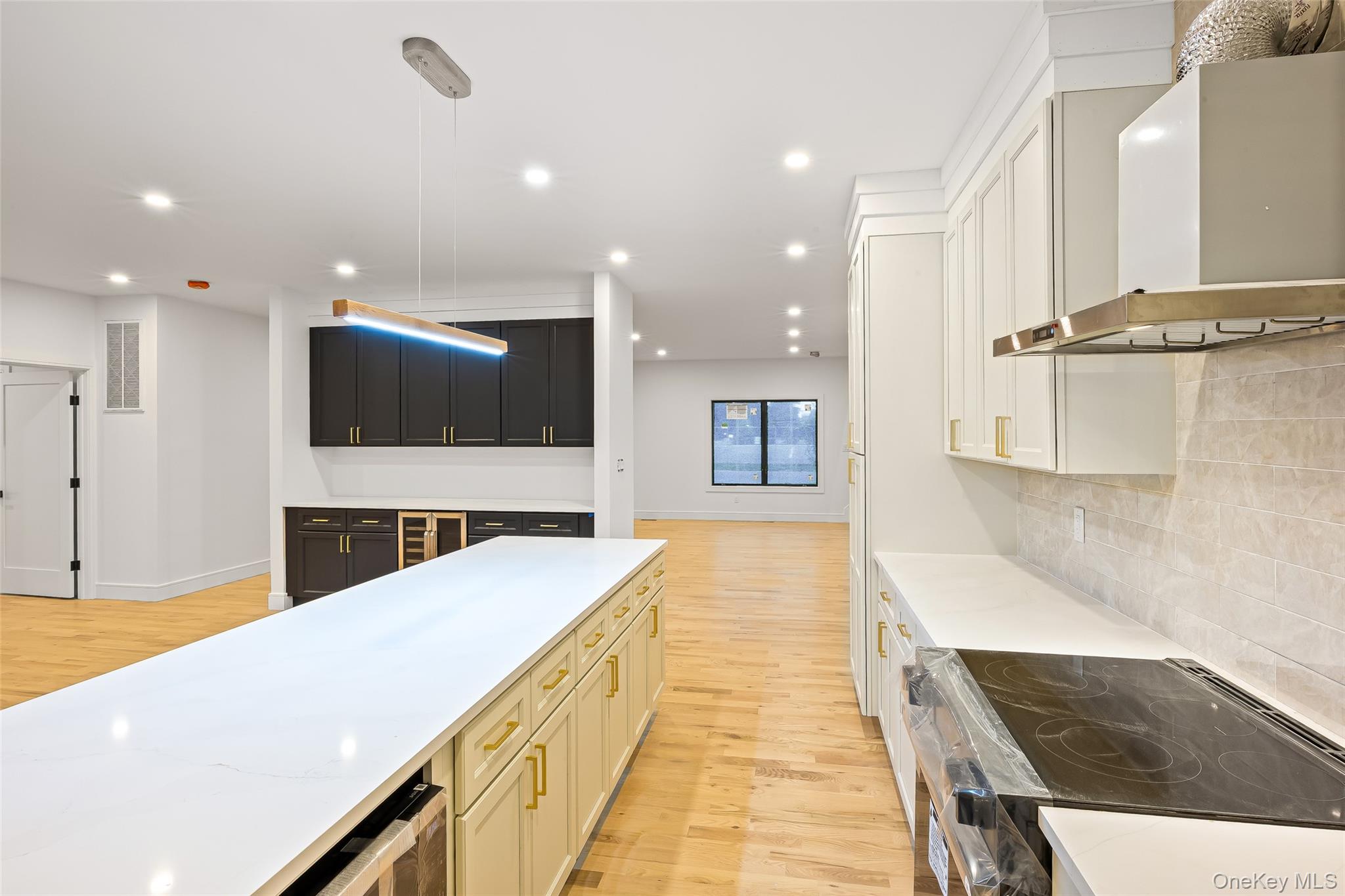 26 Tremont Avenue Patchogue, NY 11772 - Photo 38 of 50 a large hall with stainless steel appliances kitchen island a large island in it