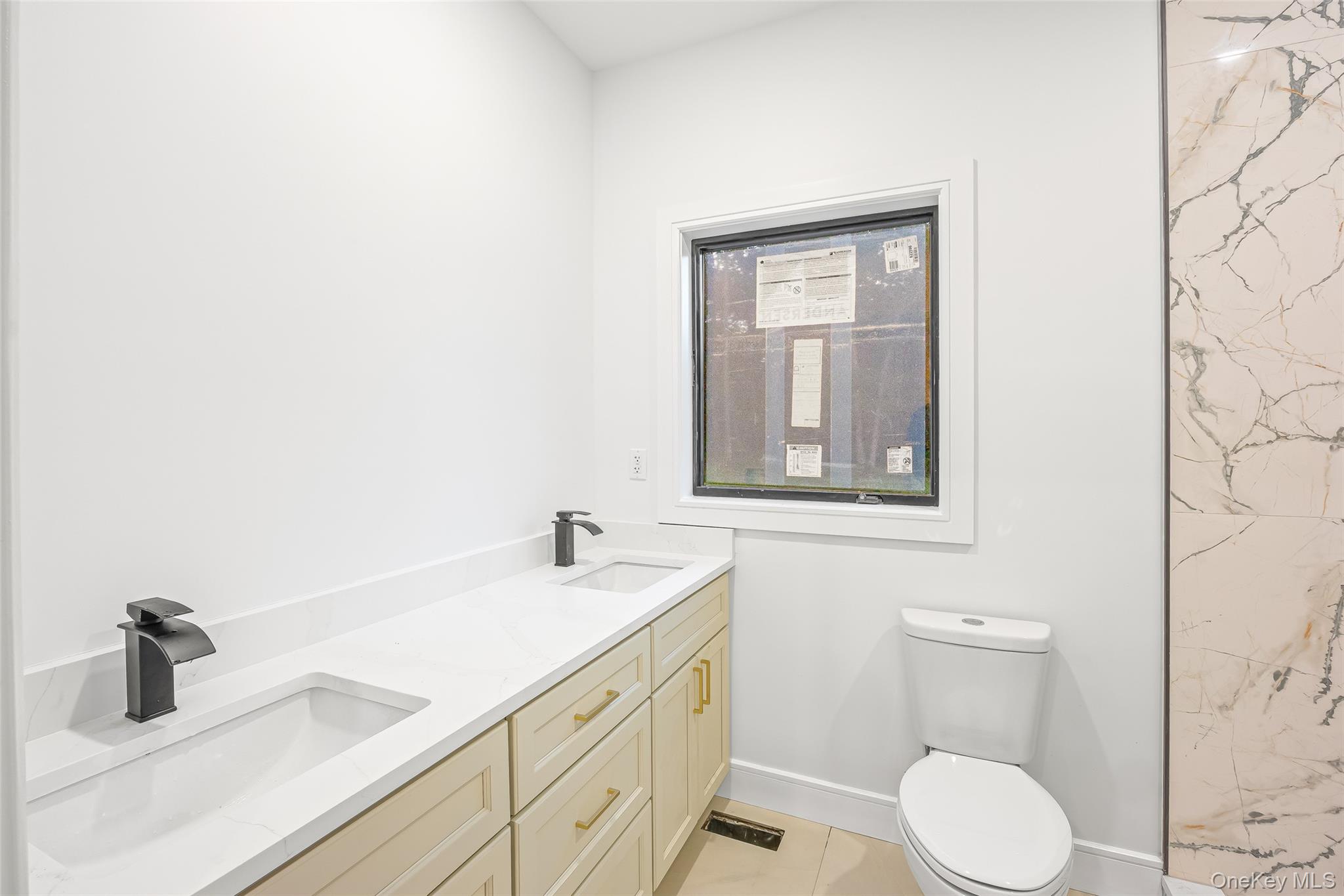 26 Tremont Avenue Patchogue, NY 11772 - Photo 41 of 50 a bathroom with a toilet sink and mirror