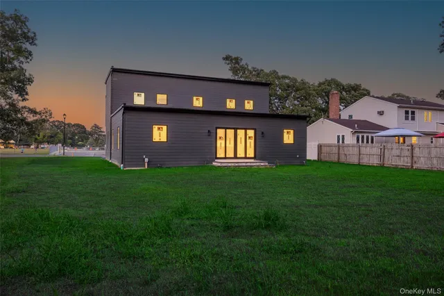a view of a big house with a big yard and large trees