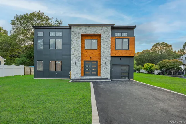 a view of a brick house with a yard and large windows