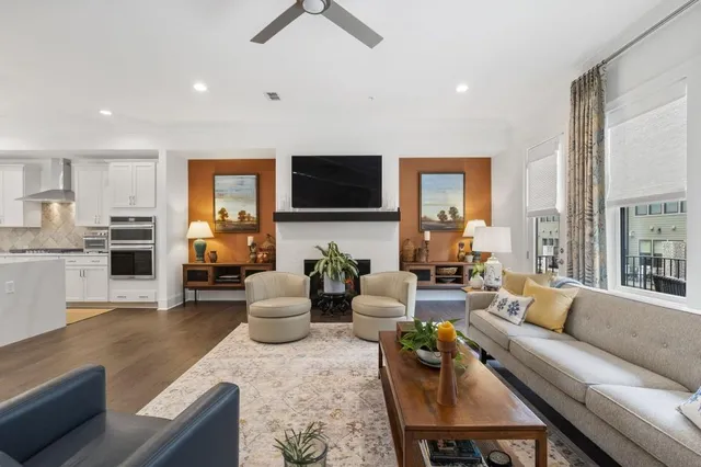 a living room with furniture a flat screen tv and a fireplace