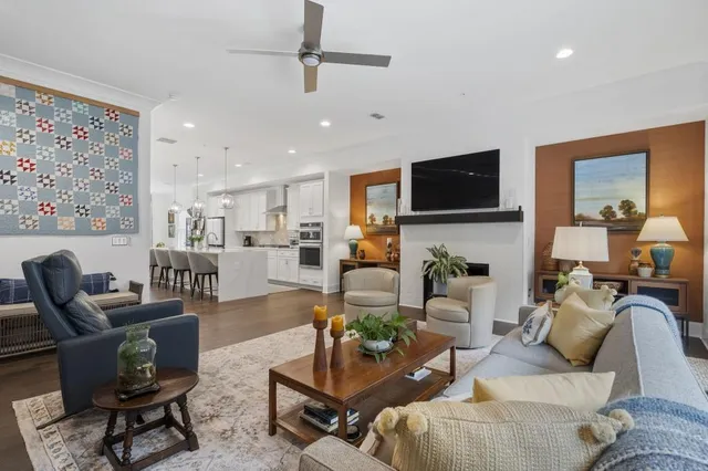 a living room with furniture and a painting on the wall