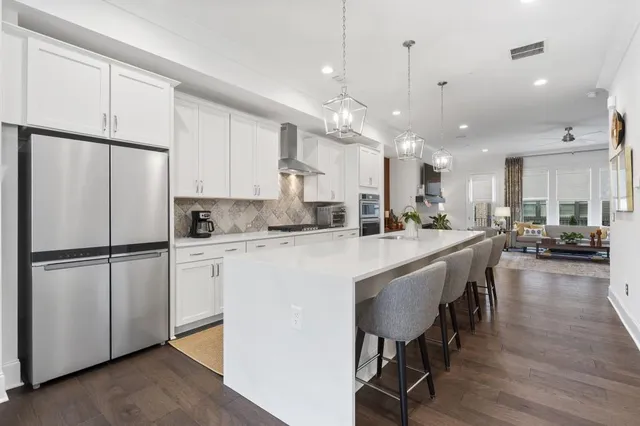 a view of a kitchen with a sink and living room view