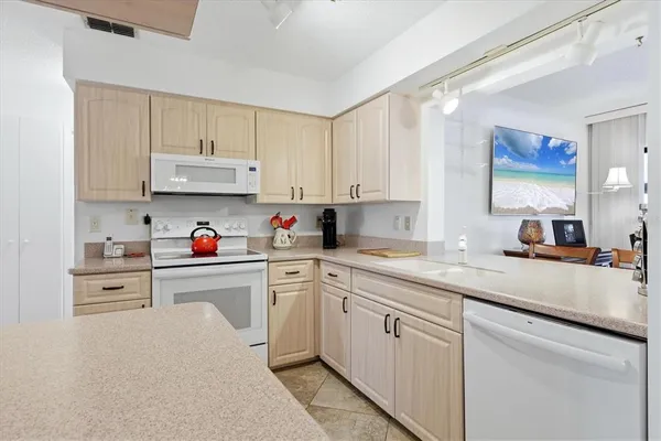 a kitchen with cabinets appliances and a sink