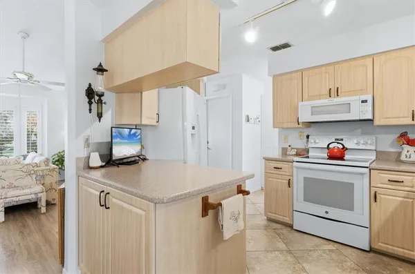 a kitchen with a sink a stove and cabinets