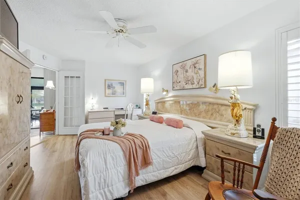 a bedroom with a bed and wooden floor