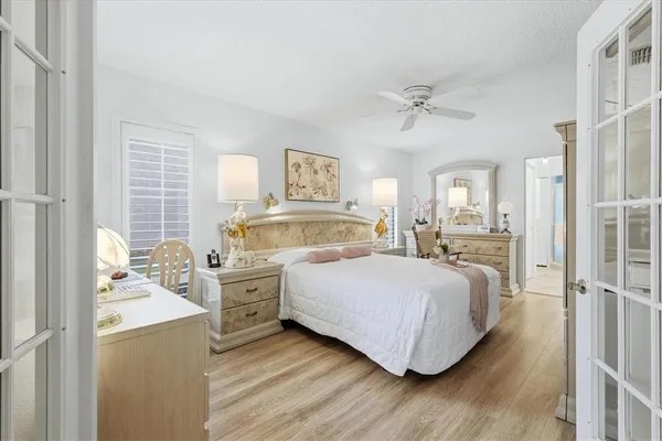 a bedroom with a bed and wooden floor