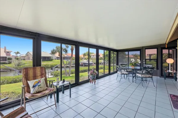 a living room with furniture and a floor to ceiling window