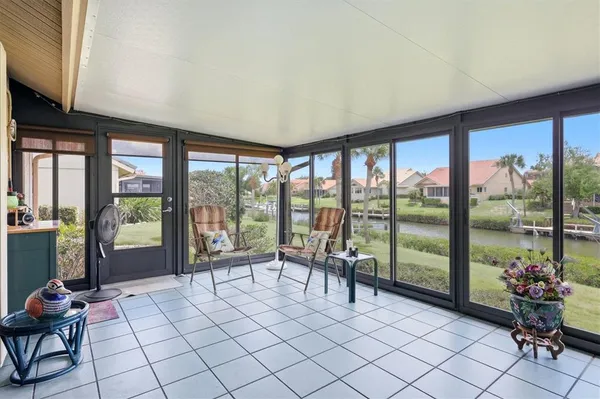 a living room with furniture and floor to ceiling windows