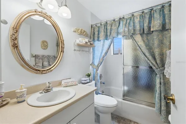 a bathroom with a toilet a sink and a mirror