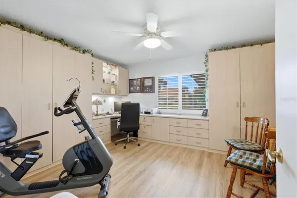a view of a workspace with furniture and a window