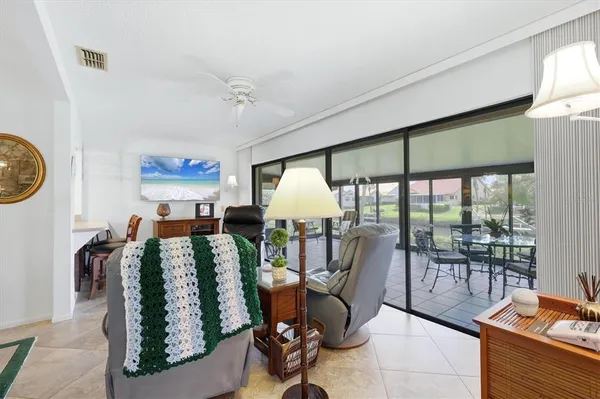 a living room with furniture and a floor to ceiling window