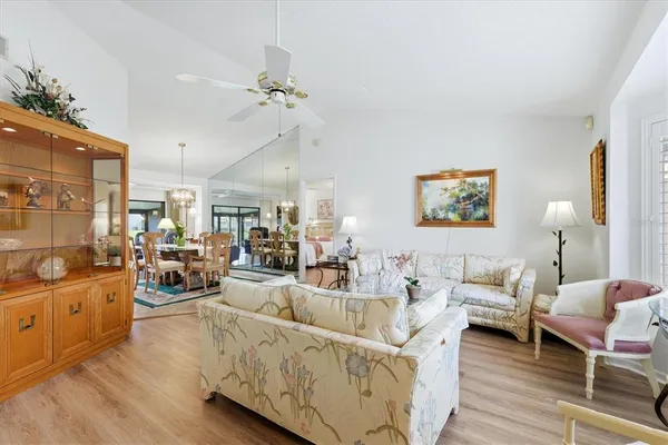 a living room with furniture and a chandelier