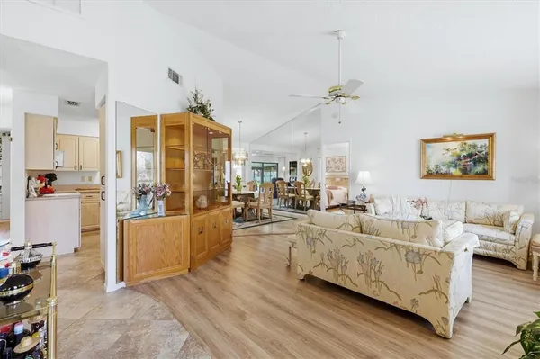a living room with furniture and a chandelier