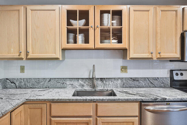 195 Falmouth Road, Unit 10E Mashpee, MA 02649 - Photo 15 of 33 a kitchen with granite countertop stainless steel appliances granite countertop white cabinets and a window