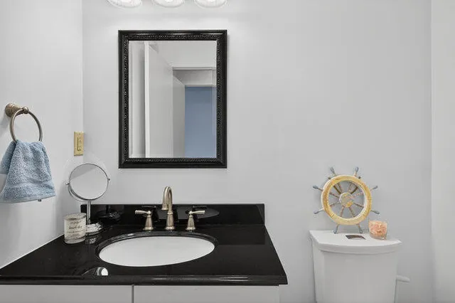 a bathroom with a sink vanity and a mirror
