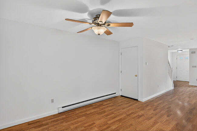 195 Falmouth Road, Unit 10E Mashpee, MA 02649 - Photo 19 of 33 a view of a room with wooden floor and ceiling fan