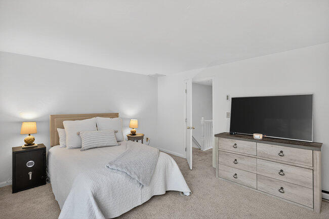 195 Falmouth Road, Unit 10E Mashpee, MA 02649 - Photo 21 of 33 a bedroom with a bed and a flat screen tv