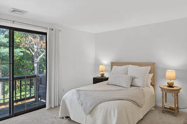 a bedroom with a bed and a large window