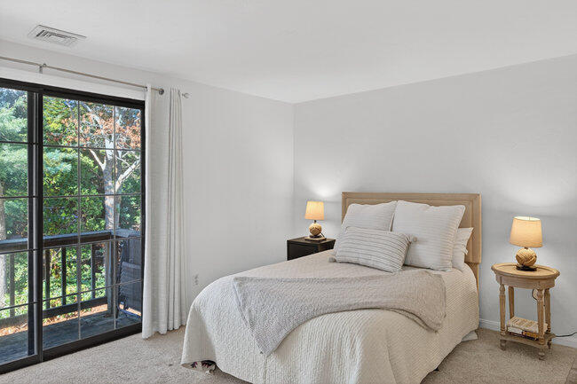 195 Falmouth Road, Unit 10E Mashpee, MA 02649 - Photo 22 of 33 a bedroom with a bed and a large window