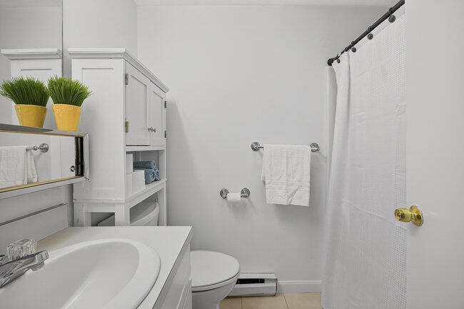 195 Falmouth Road, Unit 10E Mashpee, MA 02649 - Photo 25 of 33 a bathroom with a sink a toilet and shower